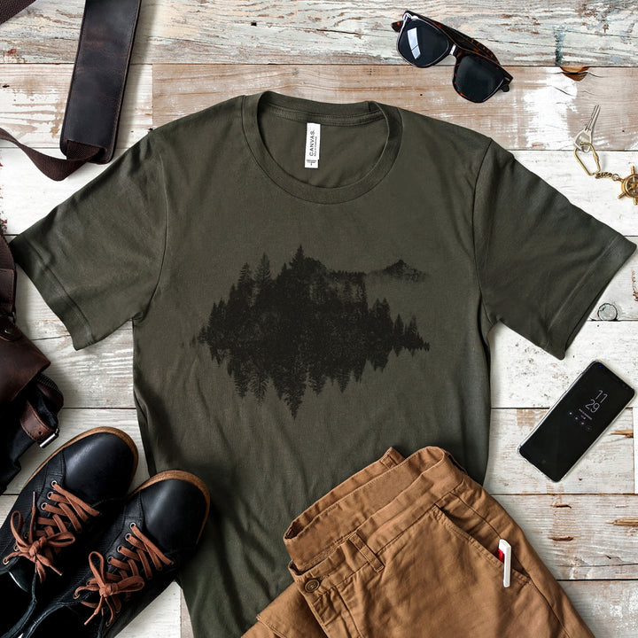 a t - shirt with a picture of a tree on it next to a pair