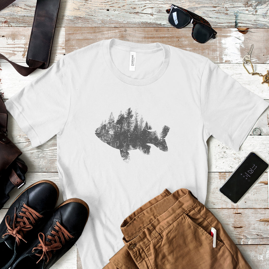 a white t - shirt with a picture of a lake surrounded by trees