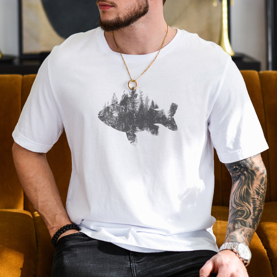 a man sitting on a couch wearing a white shirt