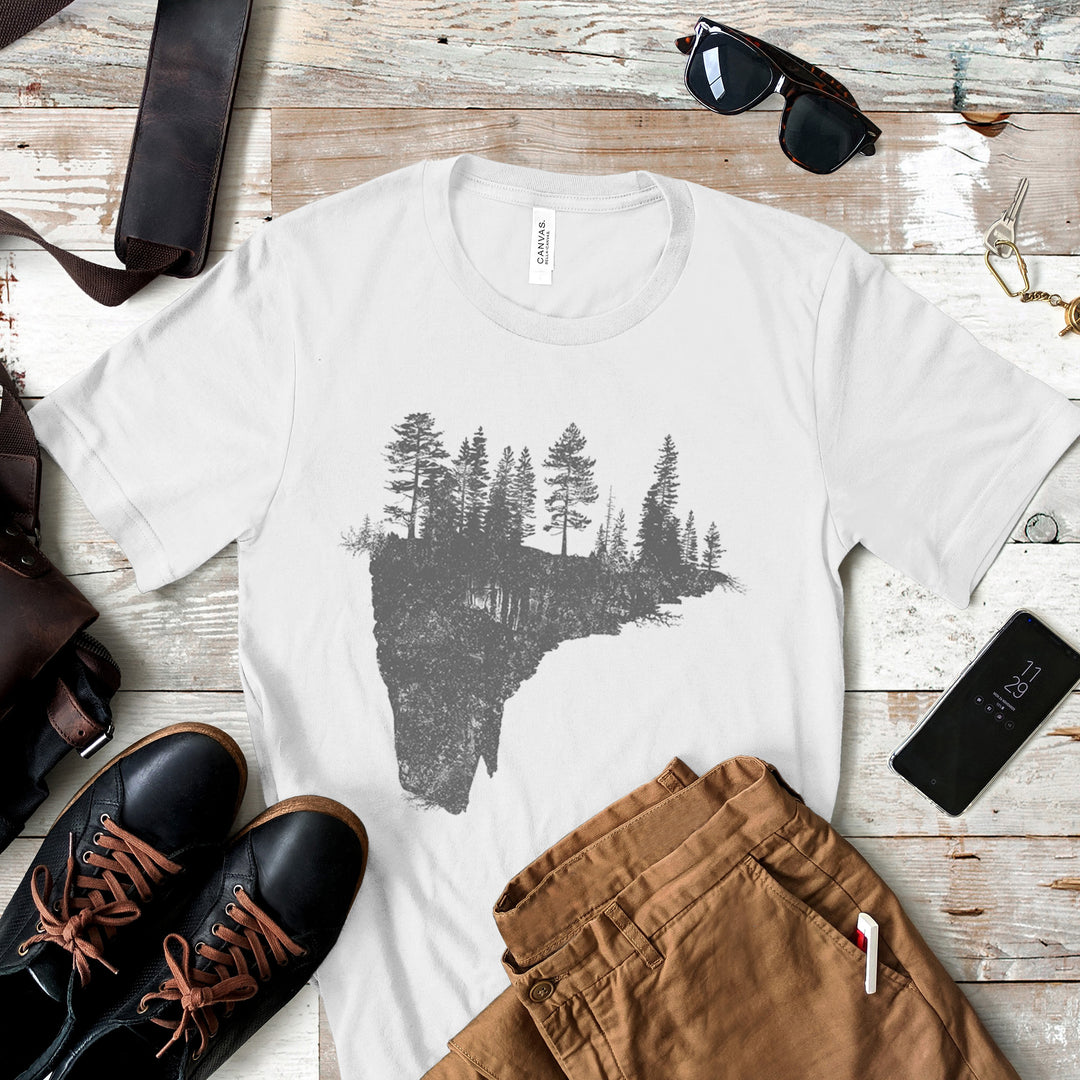 a t - shirt with a picture of a lake surrounded by trees