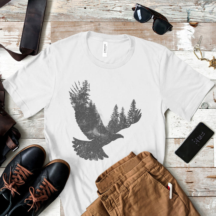 a t - shirt with a bird on it next to a pair of brown pants