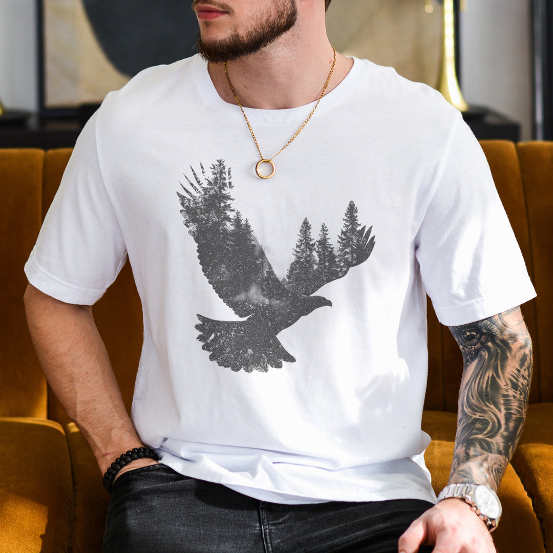 a man sitting on a couch wearing a t - shirt with a bird on it